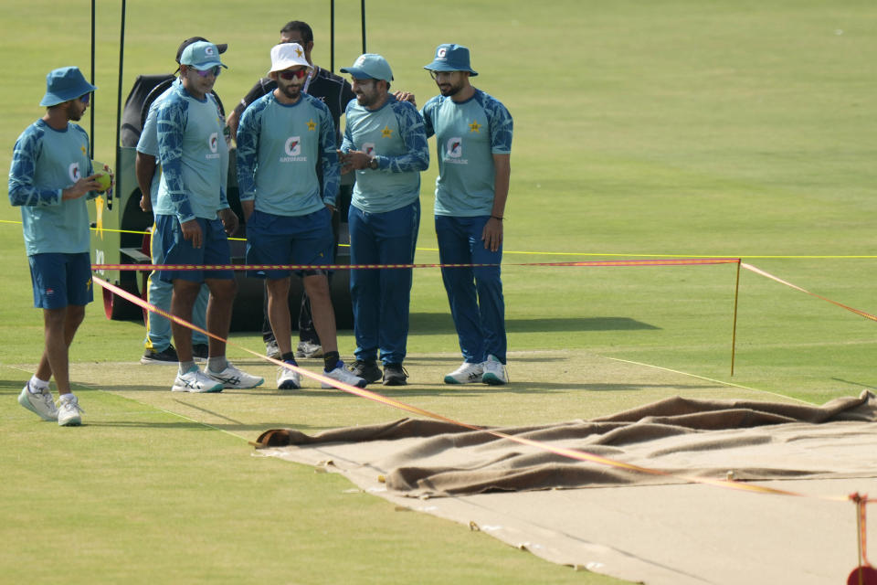 Pakistan's Sarfaraz Ahmed, second right, chats with teammates as they examine the pitch preparing for 1st test cricket match between England and Pakistan, before a practice session, in Multan, Pakistan, Sunday, Oct. 6, 2024. (AP Photo/Anjum Naveed)