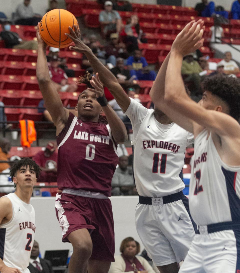 Lake Worth High School's Calvin Sirmans (0) goes up for a basket during the second half against Columbus High School during the FHSAA Boys 7A semifinal game at The RP Funding Center in Lakeland Friday afternoon. March 4, 2022. MICHAEL WILSON | LEDGER CORRESPONDENT