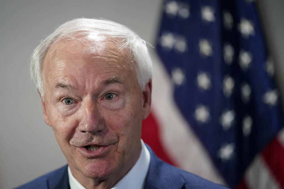 FILE - Republican presidential candidate former Arkansas Gov. Asa Hutchinson speaks to reporters after meet and greet at the VFW Post 9127, Thursday, April 13, 2023, in Des Moines, Iowa. Hutchinson formally launched his campaign Wednesday. (AP Photo/Charlie Neibergall, File)