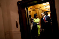 <p>Michelle and Barack get the giggles whilst Barack eats a tortilla in a lift. <em>[Photo: Getty]</em> </p>
