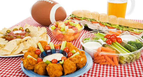 B9167H Table setting with appetizer trays for football party. Horizontal view on white background. Football; Superbowl; Amer