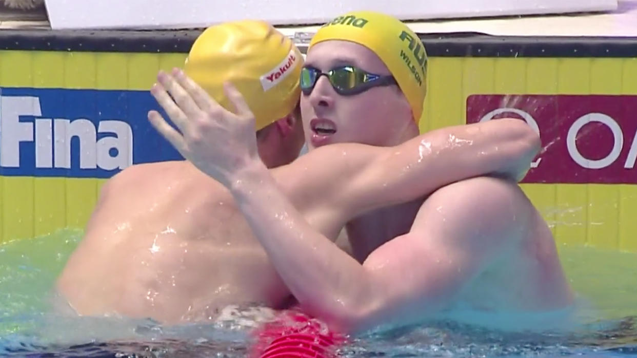 Matt Wilson (pictured right) hugs fellow Australian competitor after equalling the Men's 200m breaststroke world record at the FINA World Championships.