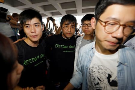 FILE PHOTO: Student leaders Lester Shum, Alex Chow, Joshua Wong and Nathan Law hold hands as they walk into the High Court to face verdict on charges relating to the 2014 pro-democracy Umbrella Movement, also known as Occupy Central protests, in Hong Kong, China August 17, 2017. REUTERS/Tyrone Siu