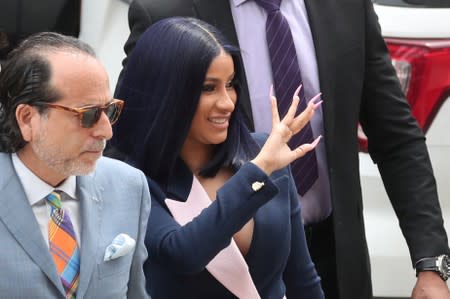 Singer Cardi B waves to fans arriving at Queens County Criminal Court in the Queens Borough of New York