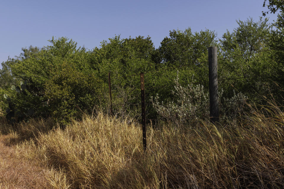 The location of a missing water station for immigrants containing sealed jugs of fresh water sits along a fence line near a roadway in rural Jim Hogg County, Texas, Tuesday, July 25, 2023. The South Texas Human Rights Center maintains over 100 blue barrels consistently stocked with water across rural South Texas to serve as a life-saving measure for immigrants who have crossed into the United States to travel north in the sweltering heat. (AP Photo/Michael Gonzalez)