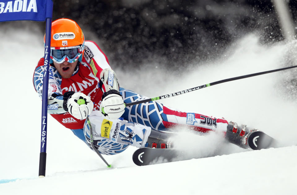 FILE - Ted Ligety of the United States passes a gate during the first run of an alpine ski men's World Cup giant slalom race, in Alta Badia, Italy, in this Sunday, Dec. 19, 2010, file photo. Two-time Olympic champion Ted Ligety says he will retire from World Cup ski racing after the world championships. Ligety’s final race will be the giant slalom on Feb. 19 in Cortina d’Ampezzo, Italy. (AP Photo/Marco Trovati, File)