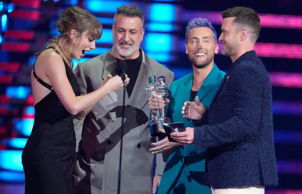 NSYNC present Swift with an award (Invision)