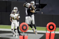 Las Vegas Raiders quarterback Derek Carr (4) celebrates after throwing a touchdown pass to tight end Darren Waller (83) during the second half of an NFL football game, Monday, Sept. 21, 2020, in Las Vegas. (AP Photo/Isaac Brekken)