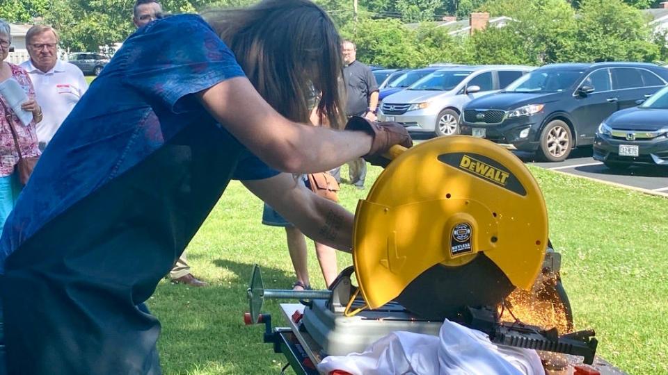 Ryan Lindsey cutting up an AR-15 at Missouri Faith Voices event Tuesday afternoon at Brentwood Christian Church as a part of his work with the nonprofit Raw Tools.