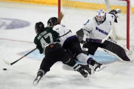 Boston forward Jamie Lee Rattray, left, and Minnesota defenseman Emily Brown, center, pursue the puck in front of Minnesota goalie Cami Kronish, right, during the second period of Game 1 of a PWHL hockey championship series, Sunday, May 19, 2024, in Lowell, Mass. (AP Photo/Steven Senne)