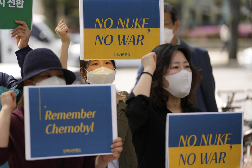 Members of South Korean civic groups shout slogans during a rally to mark the 36th anniversary of the 1986 Chernobyl nuclear disaster in Seoul, South Korea, Tuesday, April 26, 2022. (AP Photo/Lee Jin-man)