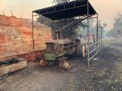 A tractor destroyed by the Sand Fire is seen at a farm in the Capay Valley in California