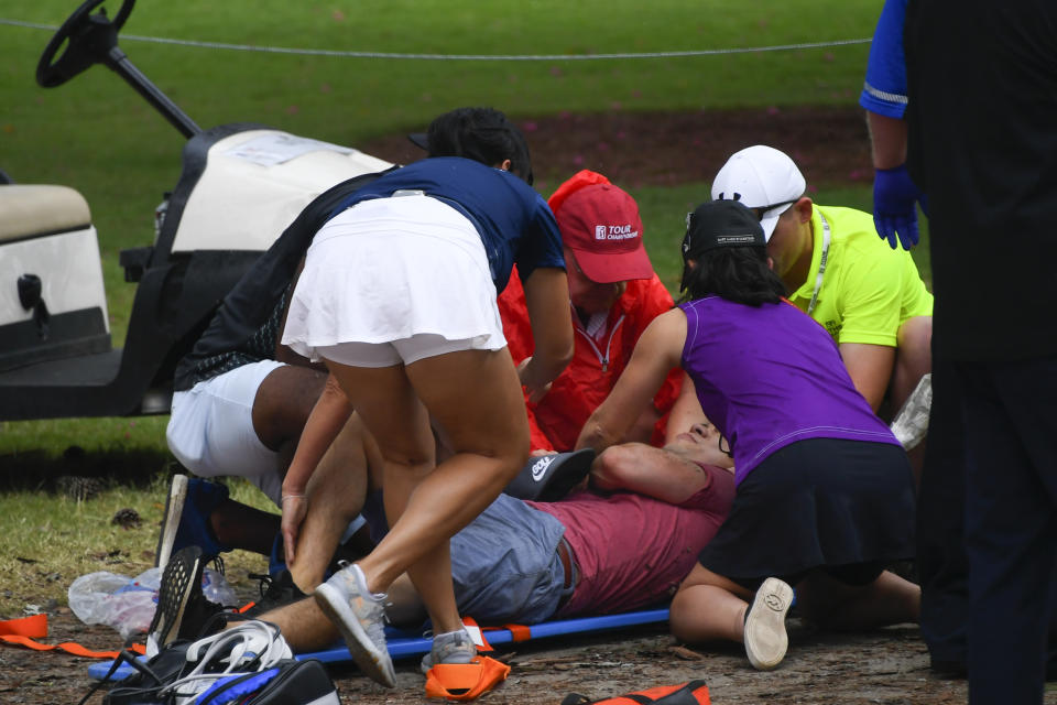 A spectators is tended to after a lightning strike on the course which left several injured during a weather delay in the third round of the Tour Championship golf tournament Saturday, Aug. 24, 2019, in Atlanta. (AP Photo/John Amis)