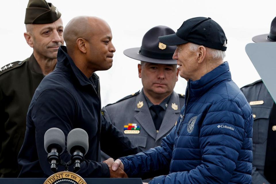 Maryland Governor Wes Moore shakes hands with President Joe Biden as they visit the site of the Key Bridge collapse on 5 April (Getty Images)