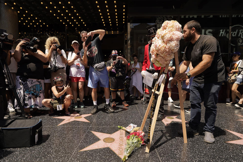 The Hollywood Chamber of Commerce honors actor Olivia Newton-John with a arrangement of pink roses on her Hollywood Walk of Fame star in Los Angeles, Monday, Aug. 8, 2022. Olivia Newton-John, the Grammy-winning superstar who reigned on pop, country, adult contemporary and dance charts with such hits as "Physical" and "You're the One That I Want" has died. She was 73. (AP Photo/Damian Dovarganes)