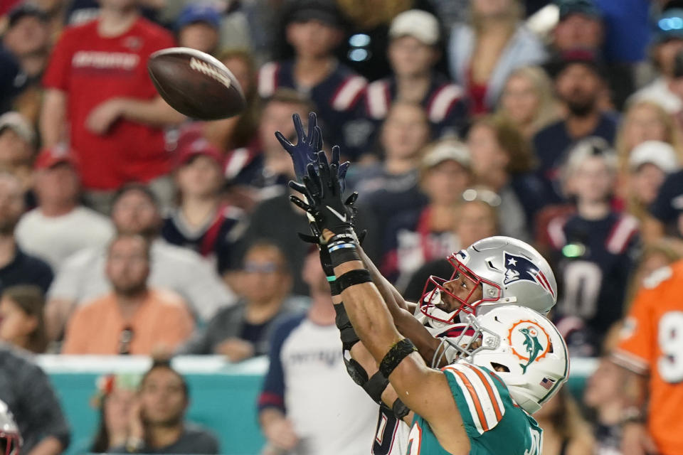 New England Patriots wide receiver Jakobi Meyers (16) makes a catch past the defense of Miami Dolphins safety Brandon Jones (29) during the second half of an NFL football game, Sunday, Jan. 9, 2022, in Miami Gardens, Fla. (AP Photo/Wilfredo Lee)