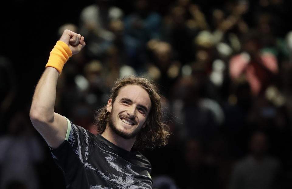 Stefanos Tsitsipas of Greece celebrates winning match point against Roger Federer of Switzerland during their ATP World Tour Finals semifinal tennis match at the O2 Arena in London, Saturday, Nov. 16, 2019. (AP Photo/Kirsty Wigglesworth)