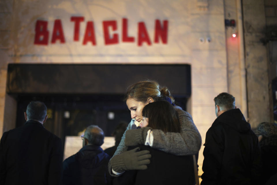 FILE - In this Nov. 13, 2016 file photo, women hug in front of the Bataclan concert hall in Paris. For more than two weeks, dozens of survivors from the Bataclan concert hall in Paris have testified in a specially designed courtroom about the Islamic State’s attacks on Nov. 13, 2015 – the deadliest in modern France. The testimony marks the first time many survivors are describing – and learning – what exactly happened that night at the Bataclan, filling in the pieces of a puzzle that is taking shape as they speak. (AP Photo/Thibault Camus, File)