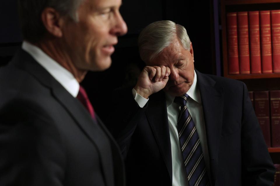 Minority Whip Sen. John Thune, R-S.D., speaks as Sen. Lindsey Graham, R-S.C., listens during a news conference at the U.S. Capitol on March 5, 2021 in Washington.