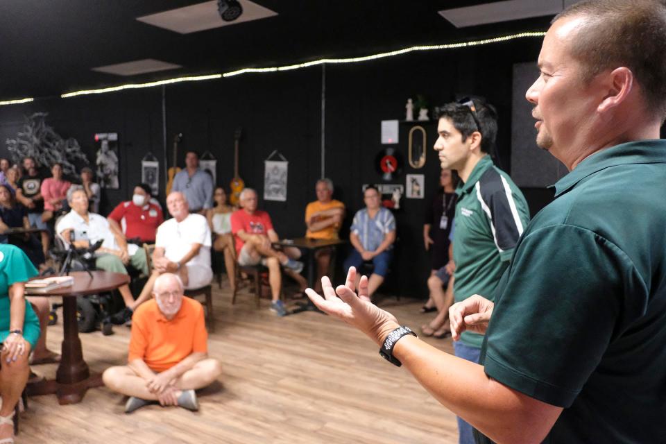 Fort Walton Beach City Manager Michael Beedie (far right) and Chris Frassetti, the city's growth management director, talk about possible timelines during a town hall meeting at Enlightened Studios to explain some preliminary density proposals for downtown.