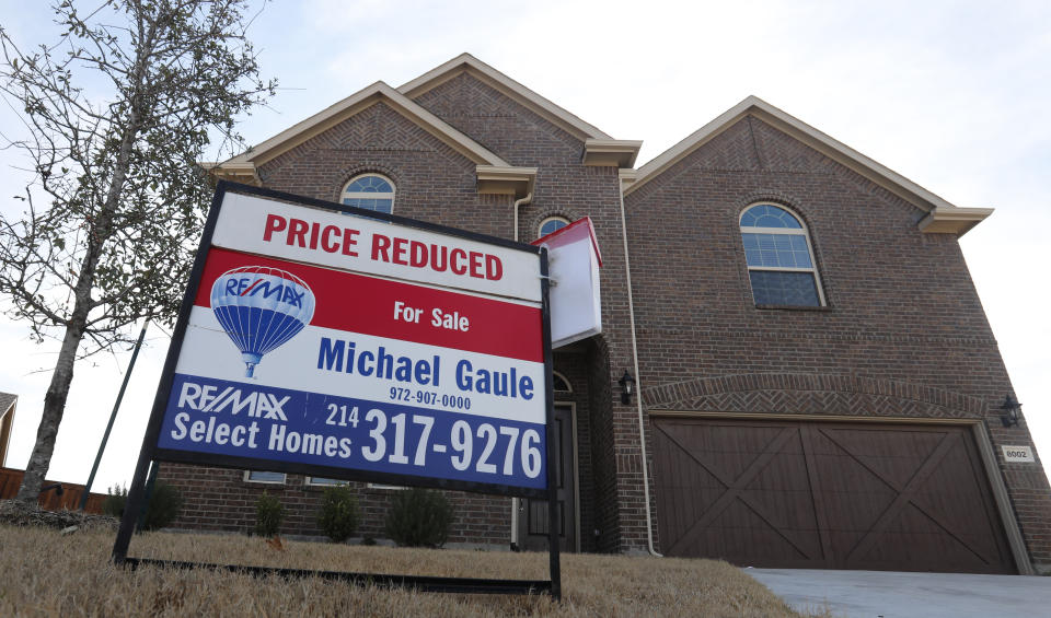 In this Wednesday, Feb. 20, 2019, photo a price reduced for sale sign sit in front of a home in north Dallas. On Thursday, Feb. 21, the National Association of Realtors reports on sales of existing homes in January. (AP Photo/LM Otero)
