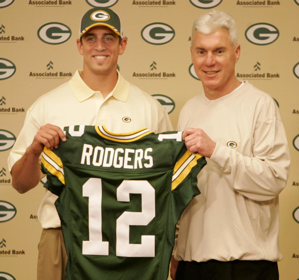 FILE - In this April 24, 2005, file photo, Green Bay Packers general manager Ted Thompson stands next to the team's first-round pick, California quarterback Aaron Rodgers, during an NFL football a news conference in Green Bay, Wis. Thompson, whose 13-year run as Green Bay Packers general manager included their 2010 Super Bowl championship season, died Wednesday, Jan 20, the team announced Thursday, Jan. 21, 2021. He was 68. Thompson was Packers general manager from 2005-17 and drafted many notable players on the current roster, including two-time MVP quarterback Aaron Rodgers. (AP Photo/Mike Roemer, File)