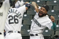 Seattle Mariners' Jose Marmolejos (26) is greeted by J.P. Crawford, right, at the dugout after hitting a two-run home run against the Los Angeles Dodgers during the first inning of a baseball game, Monday, April 19, 2021, in Seattle. (AP Photo/Ted S. Warren)