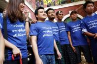 Youth activists wear blue shirts, the color of the countryÕs prison uniform, to call for freedom of expression, as they talk to the media at Insein court in Yangon