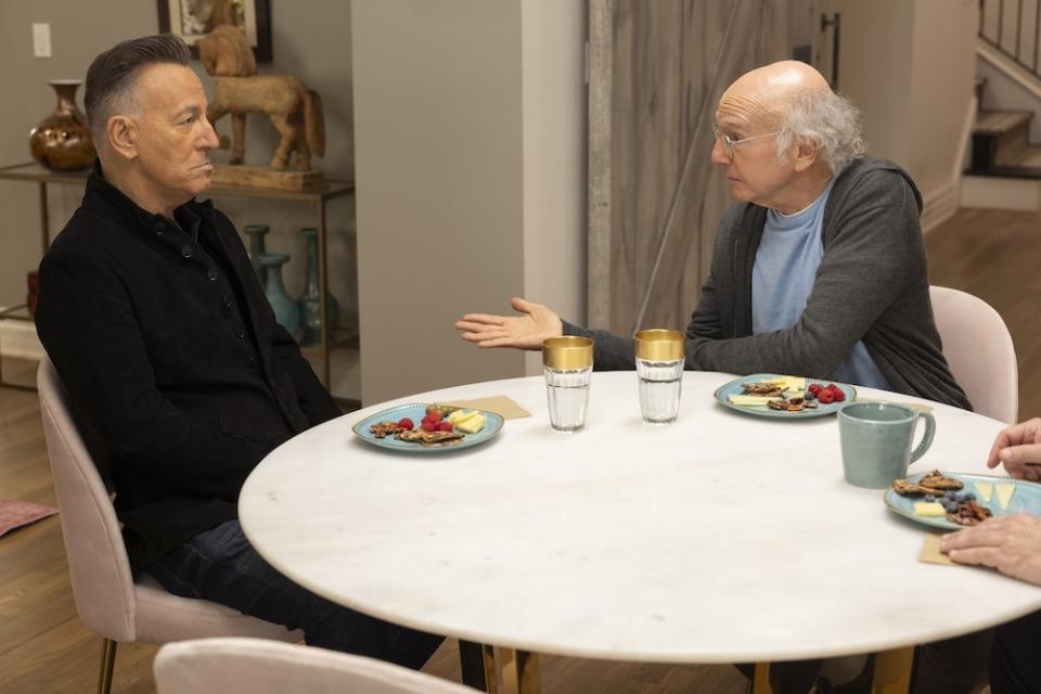 Bruce Springsteen and Larry David sit at a table in 'Curb Your Enthusiasm'