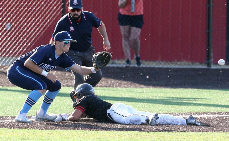 Caleb Miller, left, of Louisville awaits the throw as Will Francis of Chardon slides safetly into third base during their DII regional final at Thurman Munson Memorial Stadium on Friday, June 3, 2022.