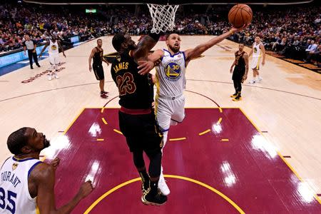 Jun 8, 2018; Cleveland, OH, USA; Golden State Warriors guard Stephen Curry (30) shoots the ball against Cleveland Cavaliers forward LeBron James (23) in game four of the 2018 NBA Finals at Quicken Loans Arena. Mandatory Credit: Gregory Shamus/pool photo-USA TODAY Sports