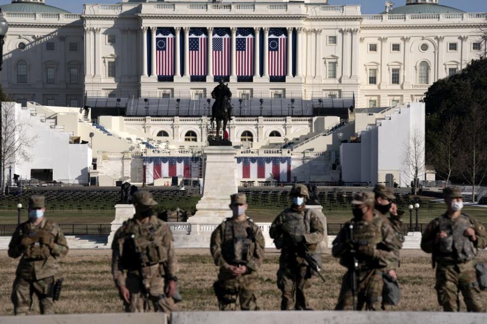 Members of the National Guard stand outside the U.S. Capitol on January 14, 2021 in Washington, DC. (Photo by Stefani Reynolds/Getty Images)