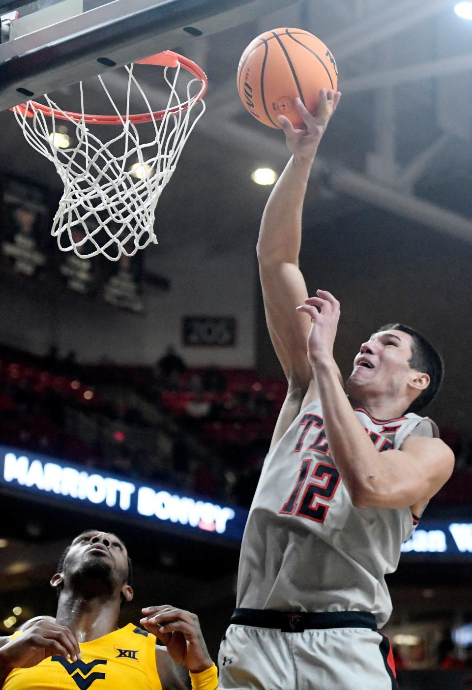 Texas Tech's forward Daniel Batcho (12) goes for a layup against West Virginia in a Big 12 basketball game, Wednesday, Jan. 25, 2023, at United Supermarkets Arena. 