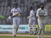 India's Mayank Agarwal, left, takes a run during the day two of their second test cricket match with New Zealand in Mumbai, India, Saturday, Dec. 4, 2021.(AP Photo/Rafiq Maqbool)