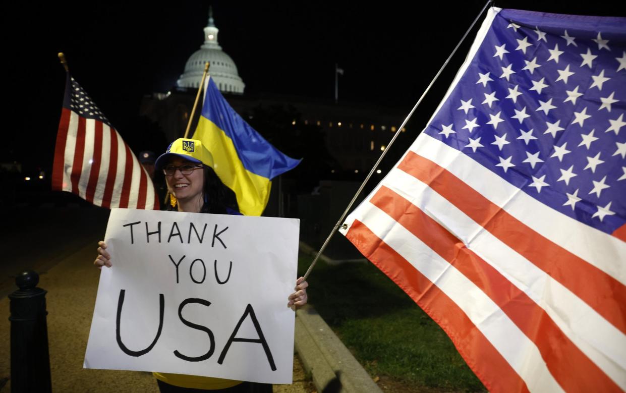 A woman holds a sign saying 'Thank you USA' in Washington DC