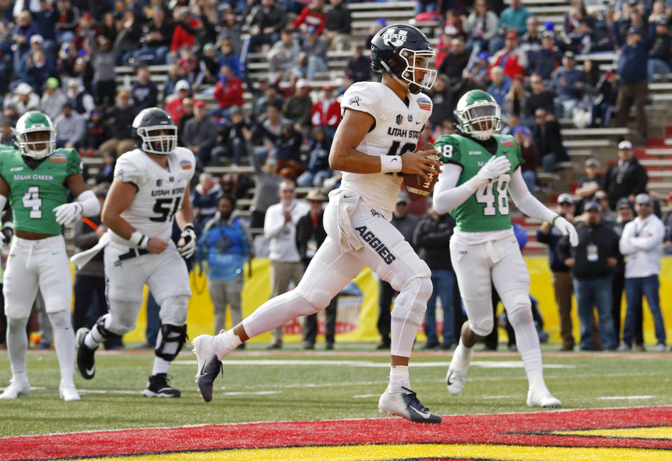 Utah State quarterback Jordan Love (10) scores a touchdown against North Texas during the first half of the New Mexico Bowl NCAA college football game in Albuquerque, N.M., Saturday, Dec. 15, 2018. (AP Photo/Andres Leighton)