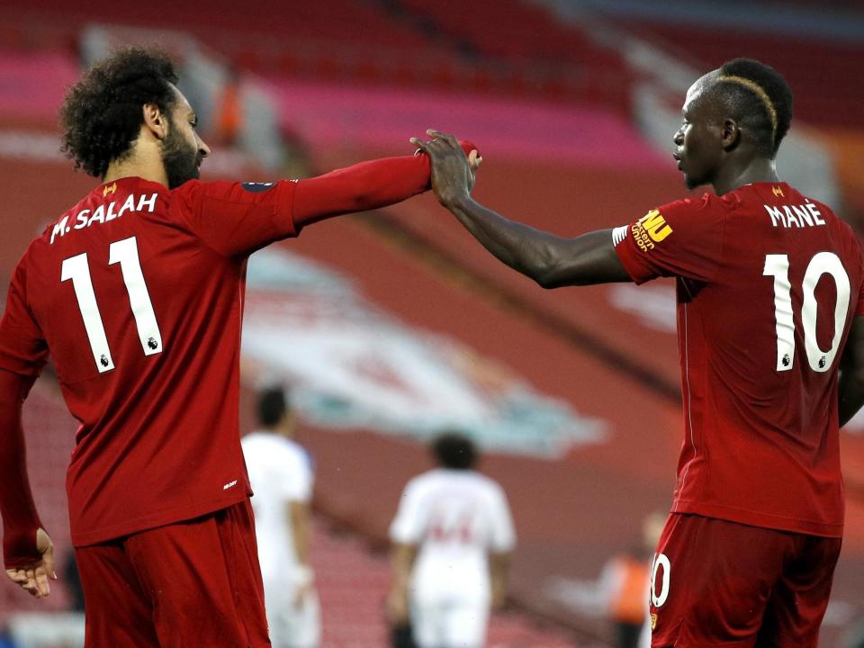 Salah and Mane celebrate against Palace: Getty