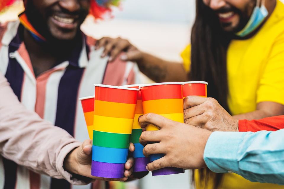 People cheering and drinking cocktails in gay pride festival event