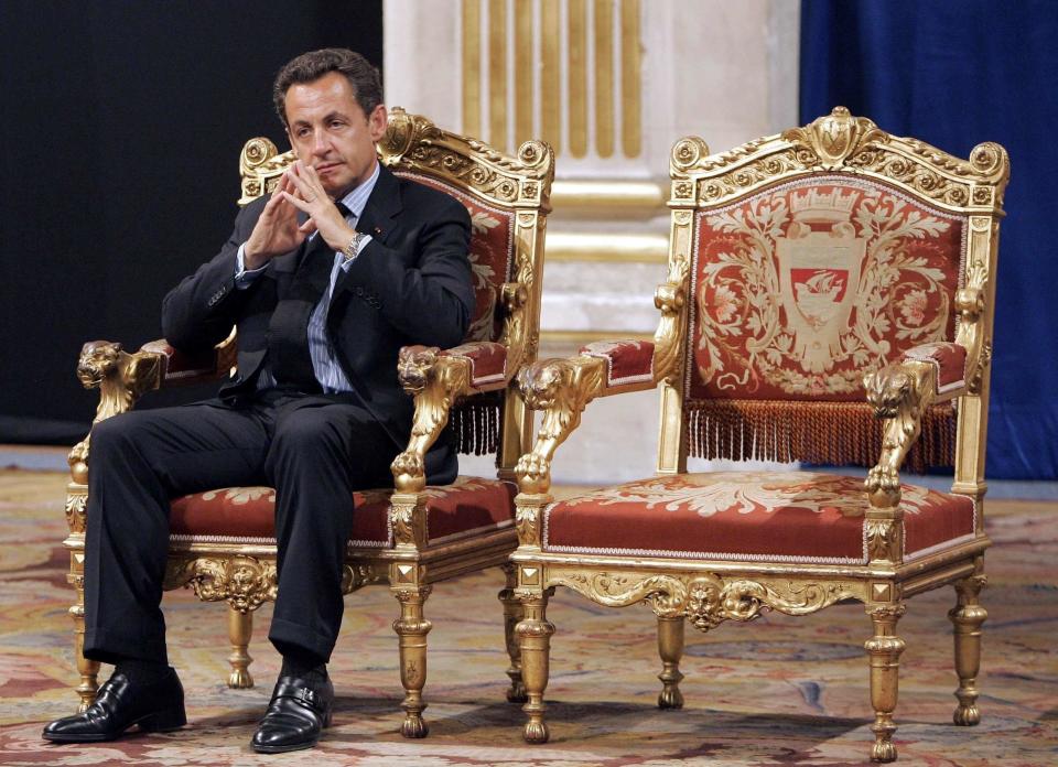 FILE - In this Thursday, May, 24, 2007 file picture, French President Nicolas Sarkozy sits during an official and traditional ceremony with Paris mayor Bertrand Delanoe, whose empty chair is at right, during which the newly elected President is met by the Paris mayor at the Paris city hall, France. The trial of former French President Nicolas Sarkozy concludes Tuesday in Paris, after a month during which the court sought to determine whether he broke laws on campaign financing in his unsuccessful 2012 re-election bid (AP Photo/Christophe Ena, File)