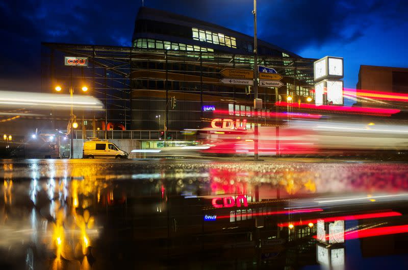 The headquarters of Germany's Christian Democratic Union Party, CDU, the party of Chancellor Angela Merkel, are reflected in a puddle in Berlin