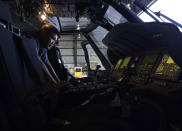 Avionics mechanic Mike Luong inspects the control panel of Sikorsky Firehawk helicopter at the California Department of Forestry and Fire Protection's Sacramento Aviation Management Unit based at McClellan Airpark in Sacramento, Calif., Friday, July 23, 2021. Firefighters are trying to become smarter in how they prepare for the drought- and wind-driven wildfires that have become more dangerous across the American West in recent years, including by adding aircraft like the Sikorsky Firehawk helicopters or military surplus C-130 transport aircraft retrofitted to drop fire retardant. (AP Photo/Rich Pedroncelli))