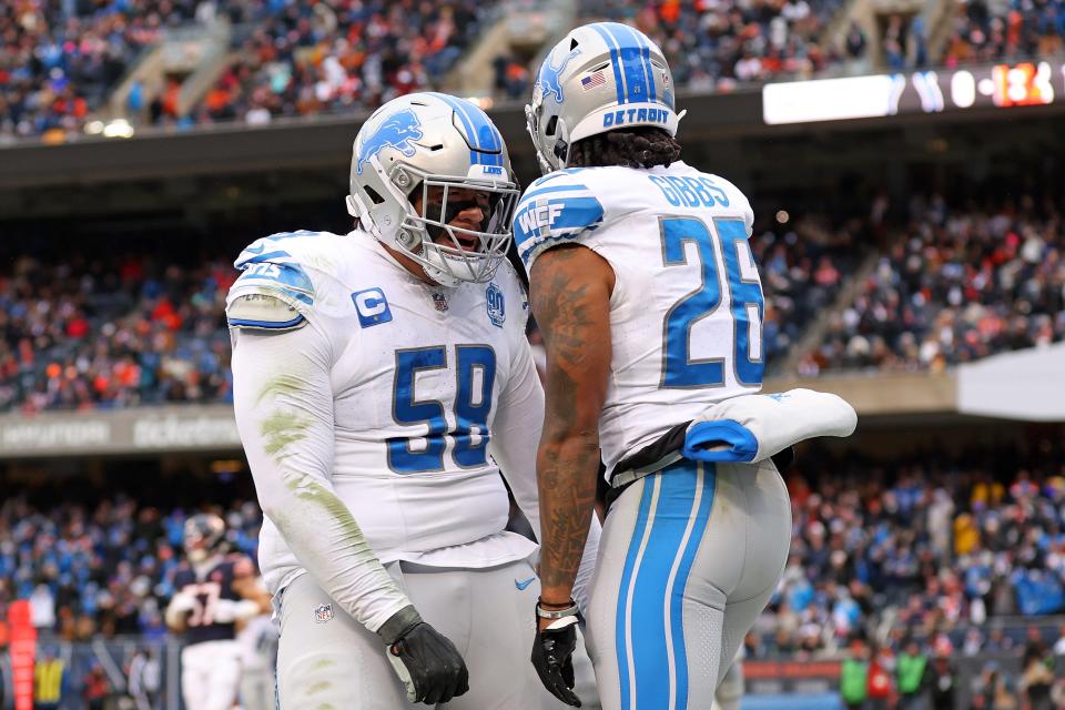 Lions running back Jahmyr Gibbs celebrates after a touchdown with offensive lineman Penei Sewell during the second quarter on Sunday, Dec. 10, 2023, in Chicago.