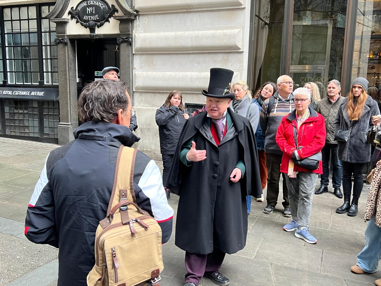 Tour guide Richard Jones speaks outside a location he believes could have been a prototype for Ebenezer Scrooge's counting house in "A Christmas Carol."