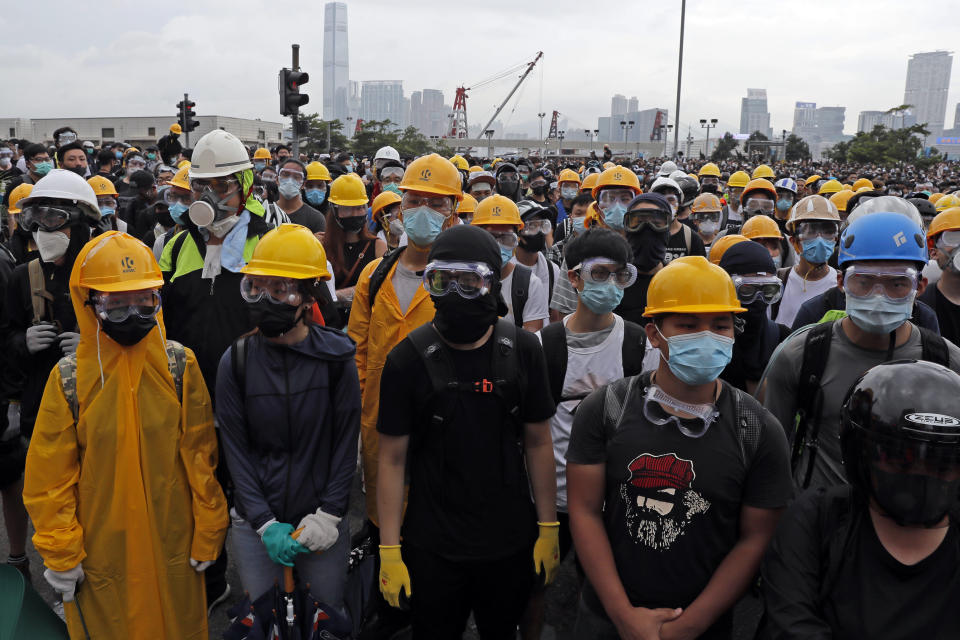 In this photo taken on Wednesday, June 12, 2019, protestors wear masks and helmets to protect their identities near the Legislative Council in Hong Kong. Young Hong Kong residents protesting a proposed extradition law that would allow suspects to be sent to China for trial are seeking to safeguard their identities from potential retaliation by authorities employing mass data collection and sophisticated facial recognition technology. (AP Photo/Kin Cheung)