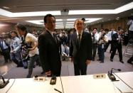 Toshiba Corp incoming President and chief executive Satoshi Tsunakawa (R) and incoming chairman Shigenori Shiga pose for a photograph at a news conference at the company headquarters in Tokyo, Japan May 6, 2016. REUTERS/Issei Kato