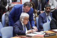 Russia's Deputy Foreign Minister Sergey Vershinin is handed some papers by an aide during high level Security Council meeting on the situation in Ukraine, Thursday, Sept. 22, 2022 at United Nations headquarters. (AP Photo/Mary Altaffer)