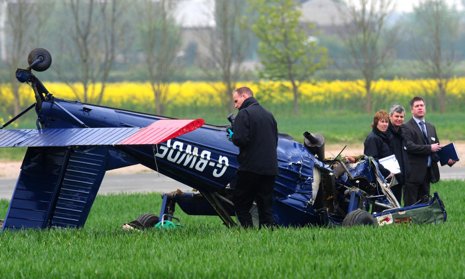 Investigators looks at wreckage of the light aircraft that crashed at Hinton-in-the-Hedges airfield, near Brackley, injuring Ukip candidate Nigel Farage and the plane's pilot.