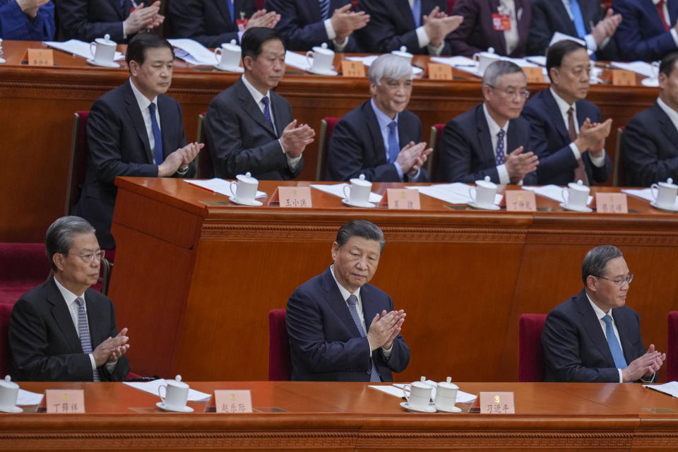 Chinese President Xi Jinping, center front, applauds during the opening session of the Chinese People's Political Consultative Conference in the Great Hall of the People in Beijing, Monday, March 4, 2024. (AP Photo/Tatan Syuflana)