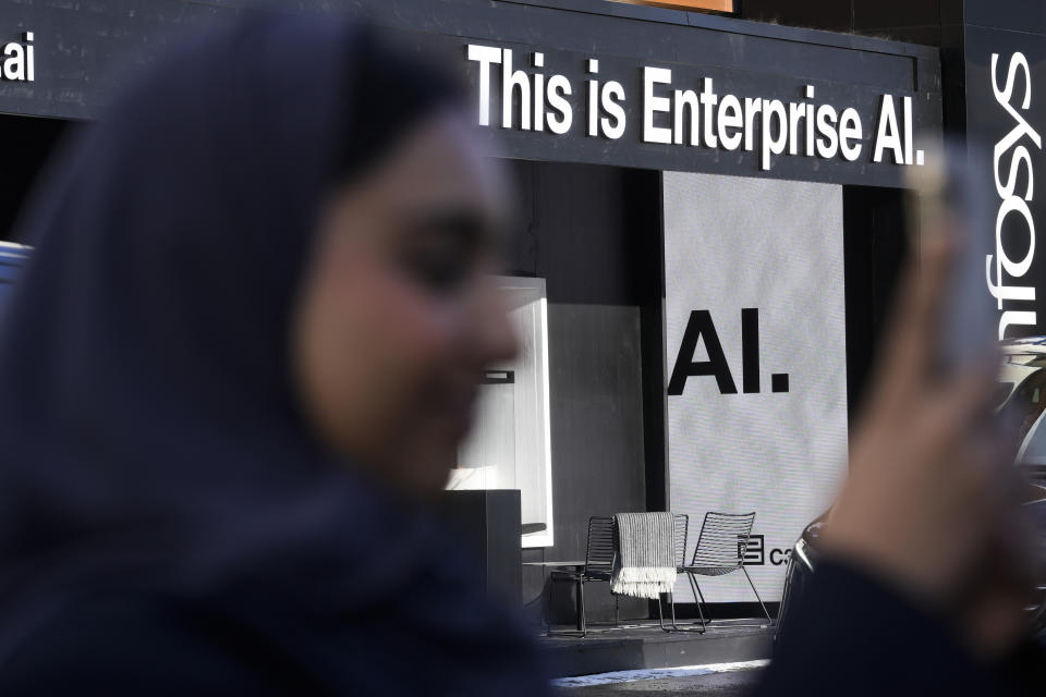 An advertisements pointing to the new AI technology displayed the Davos Promenade alongside the World Economic Forum in Davos, Switzerland, Monday, Jan. 15, 2024. The AI technology has taken a large and growing slice of attention in Davos, this year the theme of Artificial Intelligence "as a driving force for the economy and society" will get about 30 separate sessions. (AP Photo/Markus Schreiber)