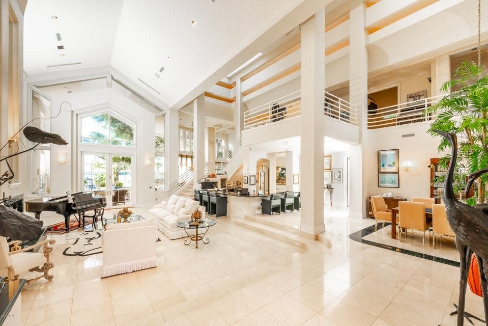 Natural light filters in through skylights that soar above this luxurious living space of this jaw-dropping waterfront estate in Daytona Beach.